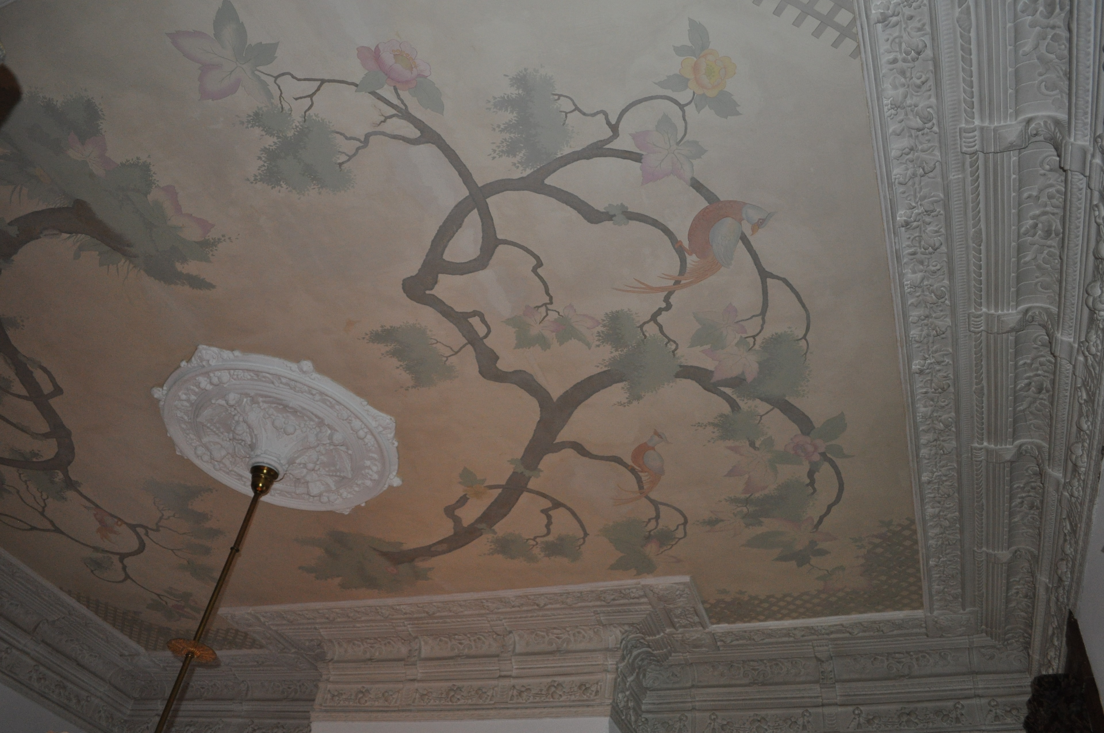 Three-quarter view of chinoiserie ceiling with light fitting and Victorian plasterwork cornice