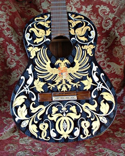 Back of the Hapsburg guitar showing the double-headed eagle in yellow gold leaf surrounded by white leaf scrollwork