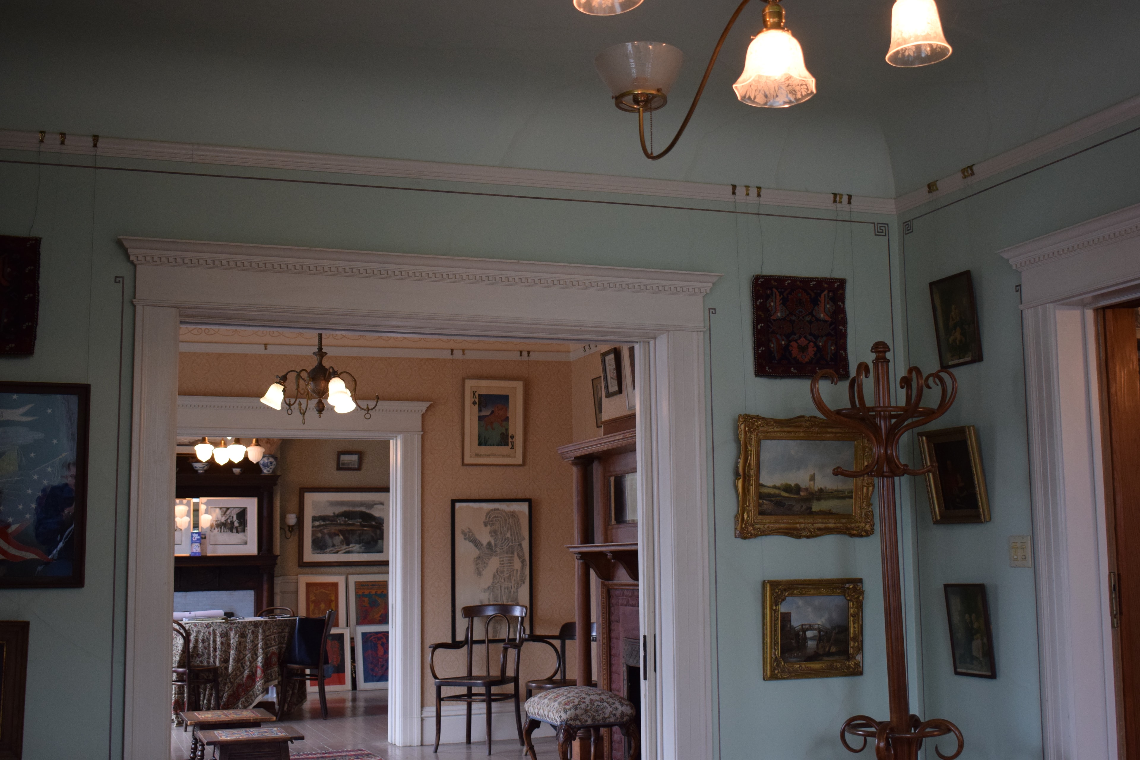 Wide view of the neo-classical sitting room showing ceiling medallion and painted banding in context
