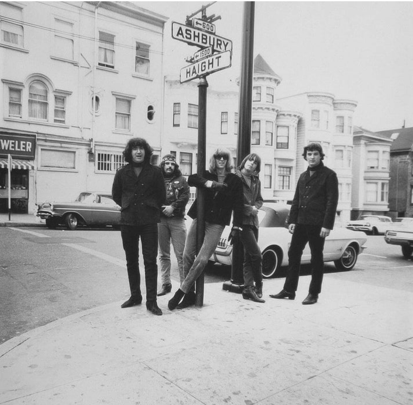The Grateful Dead at Haight and Ashbury, the arched window of the house visible in the background
