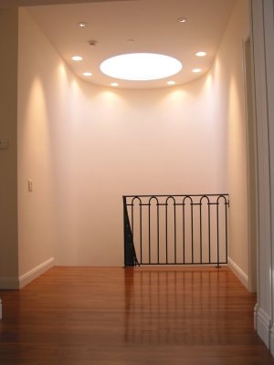 The stairway before treatment — plain white plaster walls