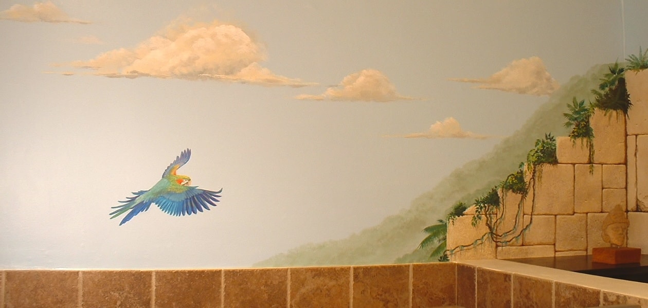 Wide view of Mayan bathroom mural with scarlet macaw in flight and pyramid in the distance