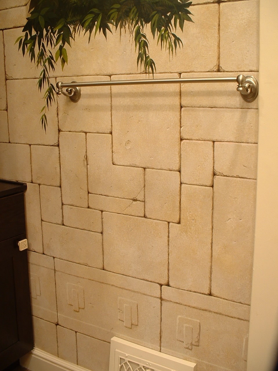 Detail of trompe l'oeil sandstone masonry and tropical foliage in Mayan bathroom mural